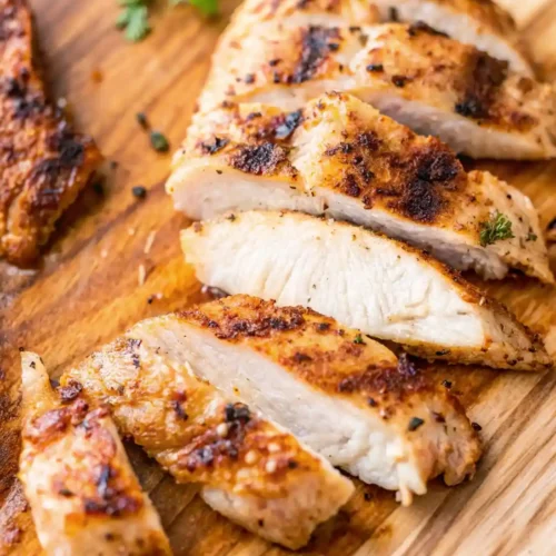 This image shows a beautifully prepared Thin Chicken Breast, seasoned with a blend of herbs and spices and grilled to golden perfection.