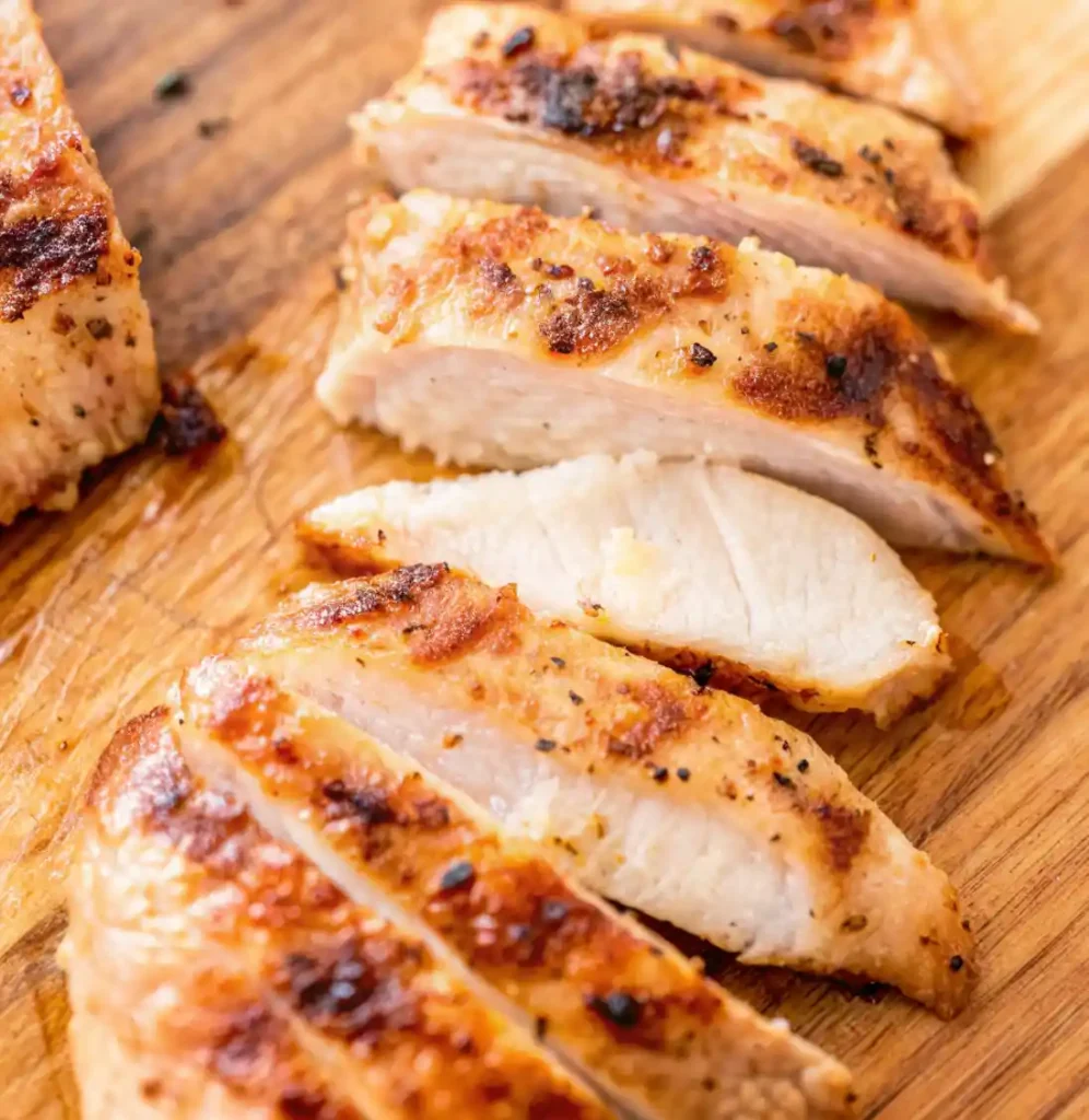 This image shows a beautifully prepared Thin Chicken Breast, seasoned with a blend of herbs and spices and grilled to golden perfection.