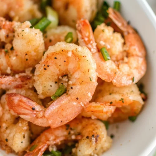 serving bowl filled with perfectly golden, crispy Salt and Pepper Shrimp, generously coated with black pepper, salt, and fresh green onions.