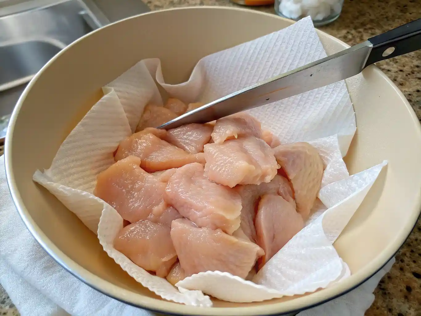 Raw chicken chunks in a bowl, ready to be seasoned for Chick fil A Grilled Nuggets Recipe