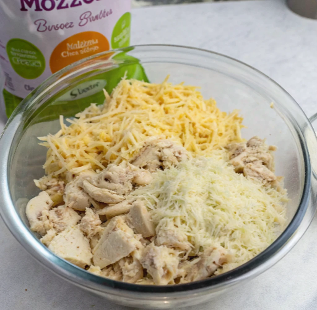 diced cooked chicken, cream cheese, shredded cheddar, mozzarella, milk, and sauce.