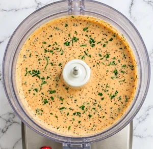 A “Ranch” mayonnaise mixture made with mayonnaise, crème fraîche, fromage blanc, chipotle pepper, adobo sauce, lemon juice, chopped cilantro, and spices—all blended together to create a creamy, orange-colored “Southwest Ranch” sauce.